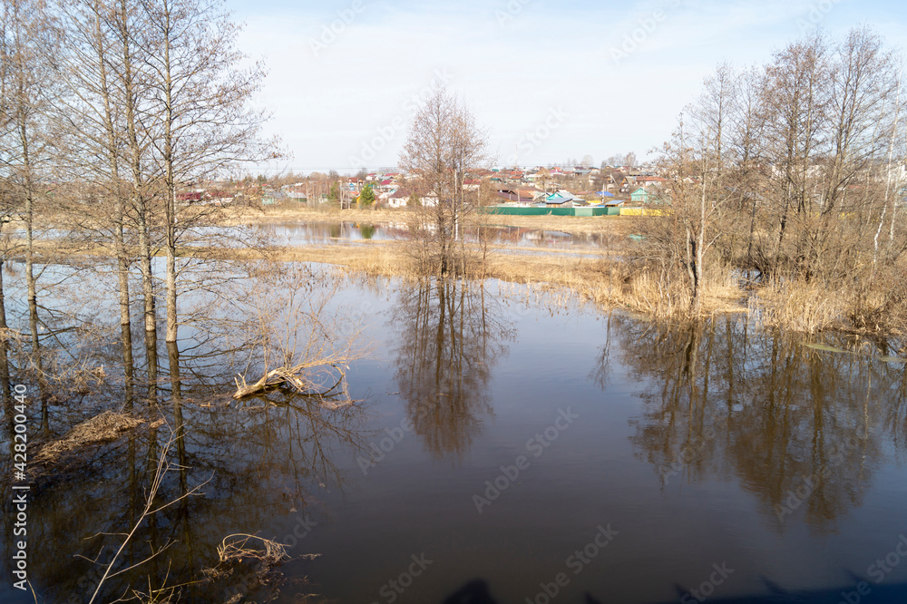 Spring landscape with a river against a blue sky Spring landscape with a river against a blue sky