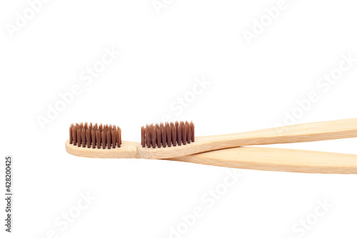 Two wooden toothbrushes isolated on a white background.