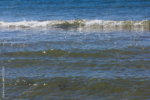 The background of sand with water splash into summer with space for text. © Olga