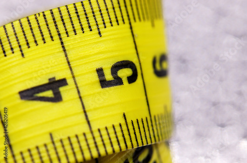 close-up yellow measuring tape on a background