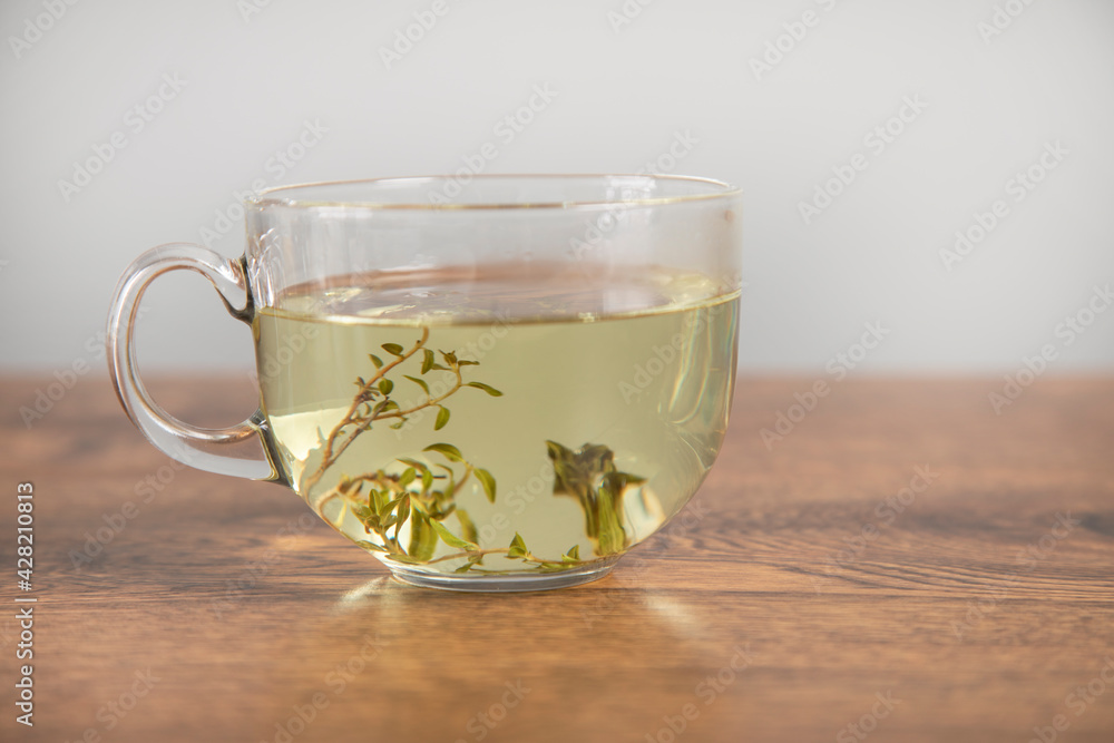 Glass cup of hot aromatic tea