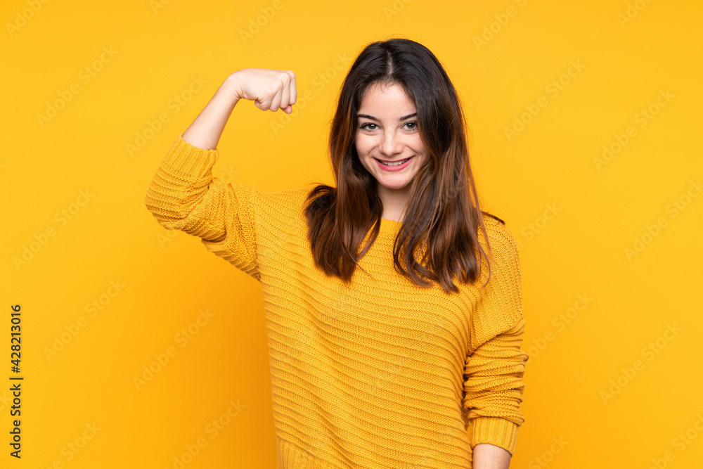 Young caucasian woman isolated on yellow background doing strong gesture Young caucasian woman isolated on yellow background doing strong gesture