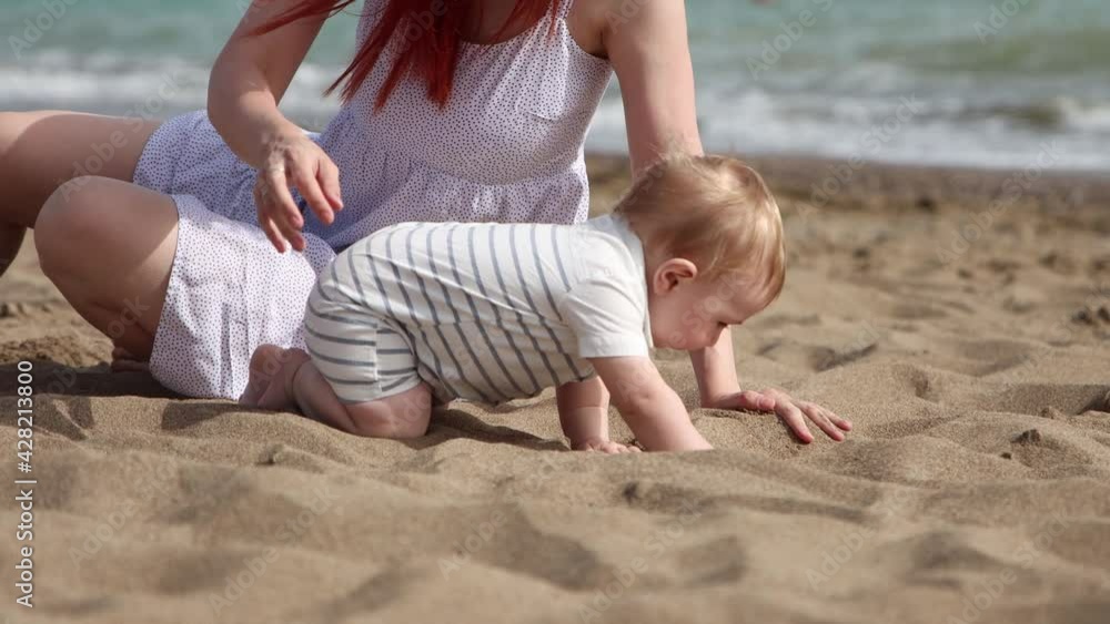 Happy mother with her little son having a rest on the beach Happy mother with her little son having a rest on the beach