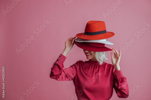 Canvas-taulu Happy smiling woman hides her face under many hapy