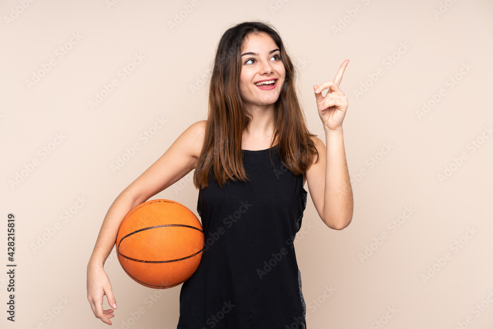 Young caucasian woman isolated on beige background playing basketball and having an idea Young caucasian woman isolated on beige background playing basketball and having an idea