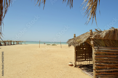 Lounges with sunbeds on the beach  Egypt. Yellow sand  blue sky. Resort  rest. Copy space for text