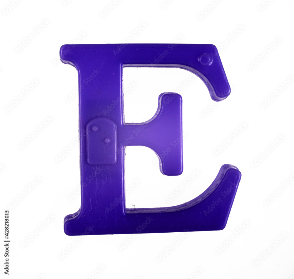 Plastic letter E of the English alphabet against white background, top view. Plastic letter E of the English alphabet against white background, top view.