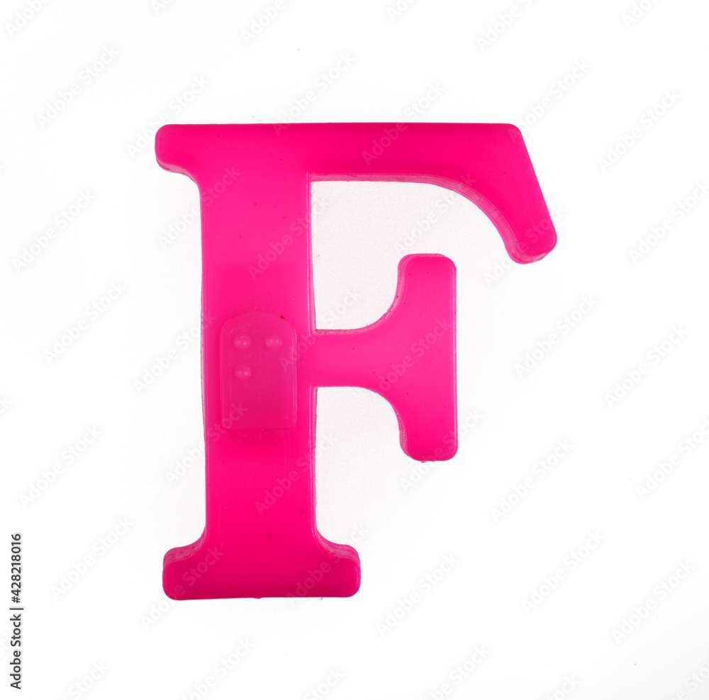 Plastic letter F of the English alphabet against white background, top view. Plastic letter F of the English alphabet against white background, top view.