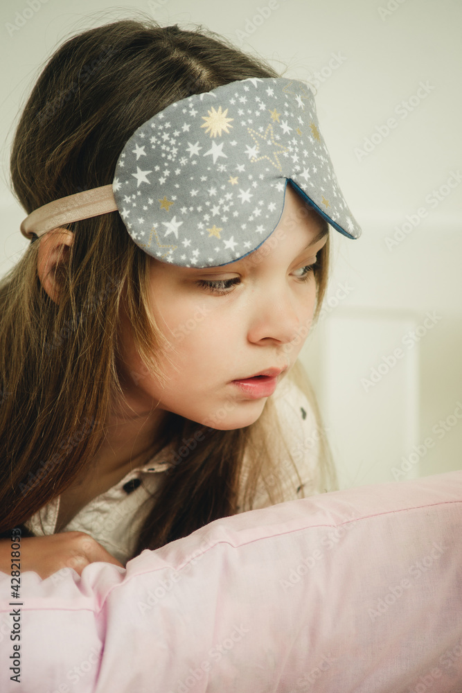 teenage girl in a mask for sleeping on the bed teenage girl in a mask for sleeping on the bed