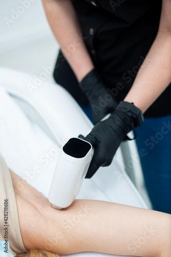woman at cosmetics salon laser epilation