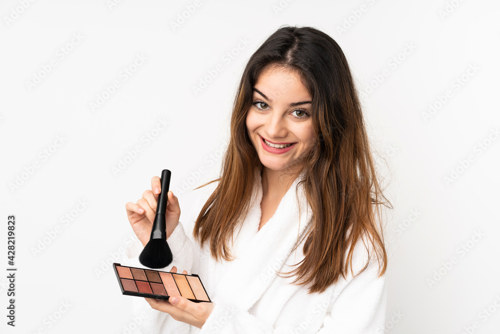 Young caucasian woman isolated on white background with makeup palette and happy Young caucasian woman isolated on white background with makeup palette and happy