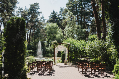 Coziness and style. Modern event design. Lounge zone and european traditional wedding ceremony decoration outdoors in the restaurant before the reception.