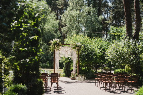 Coziness and style. Modern event design. Lounge zone and european traditional wedding ceremony decoration outdoors in the restaurant before the reception.