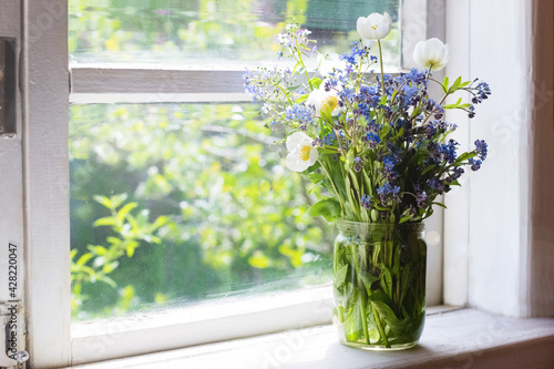 Bouquet of spring flowers on windowsill © Alusha
