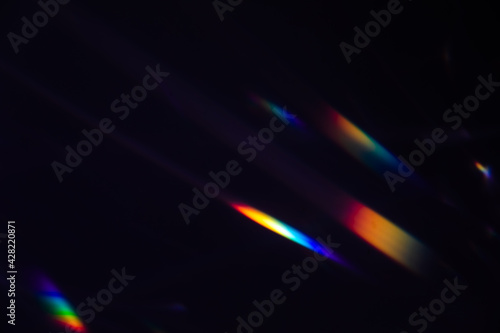 Blur colorful warm rainbow crystal light leaks on black background. Defocused abstract retro film analog effect for using over photos as overlay or screen filter photo