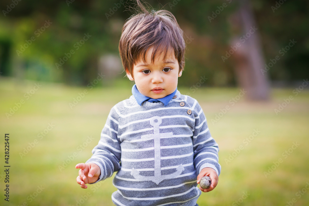 Little eastern handsome baby boy playing outdoor in the park Little eastern handsome baby boy playing outdoor in the park
