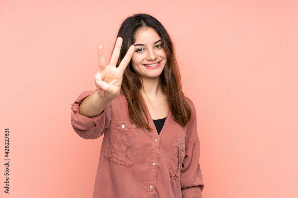 Young caucasian woman isolated on pink background happy and counting three with fingers Young caucasian woman isolated on pink background happy and counting three with fingers