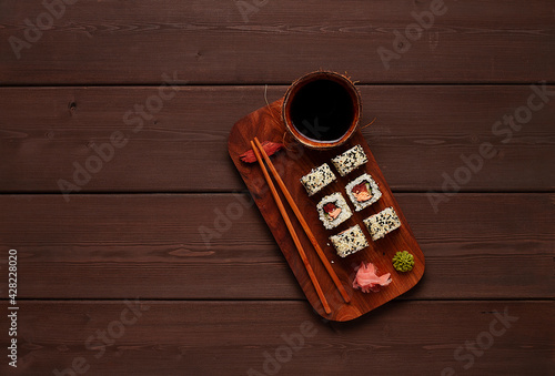 Roll Salmon teriyaki, on a wooden stand, top view, horizontal, no people,