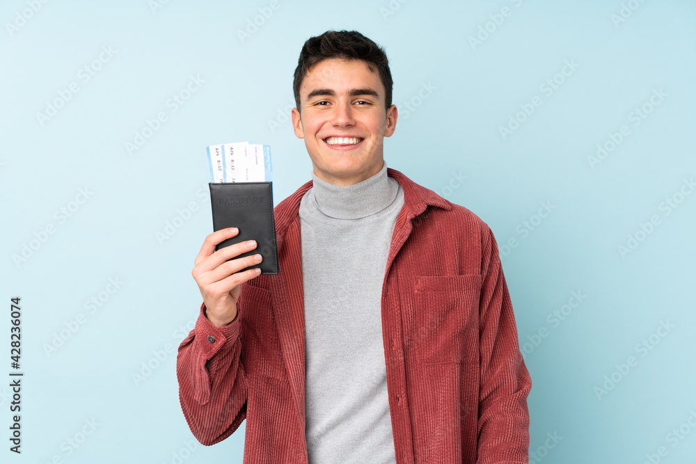 Teenager caucasian man isolated on purple background happy in vacation with passport and plane tickets Teenager caucasian man isolated on purple background happy in vacation with passport and plane tickets