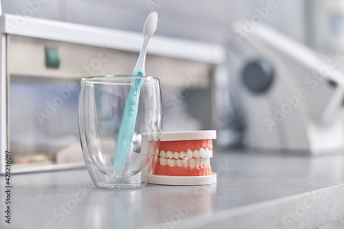 Close up about brushing teeth in clinic. Health care and maintenance with expert concept