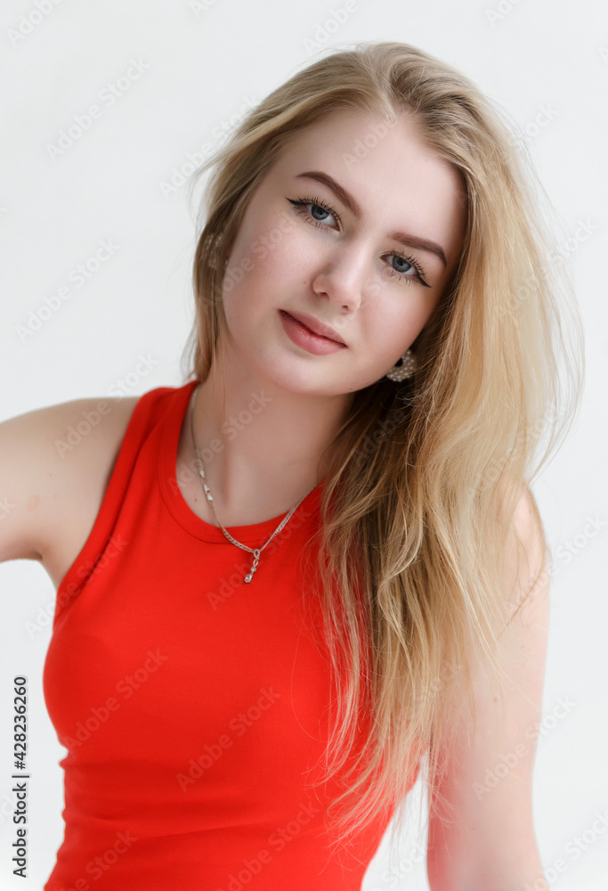 Fototapeta premium sexy young white woman in red bodysuit on white background, close up portrait