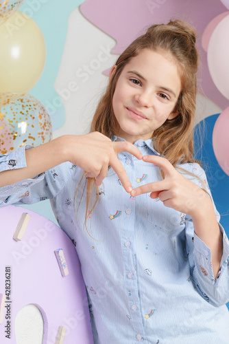 portrait of  white girl 10 years old on a light background, balloons