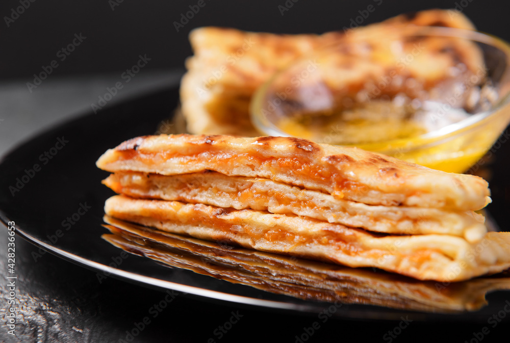 tortillas with pumpkin and butter on a black plate on a dark tortillas with pumpkin and butter on a black plate on a dark