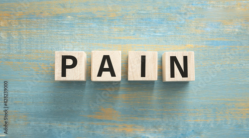 Pain word concept on wood cube, Medical concept