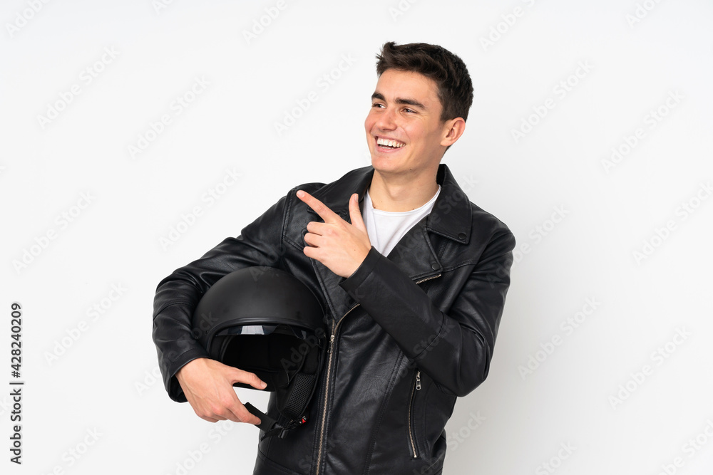 Man holding a motorcycle helmet isolated on white background pointing with the index finger a great idea Man holding a motorcycle helmet isolated on white background pointing with the index finger a great idea