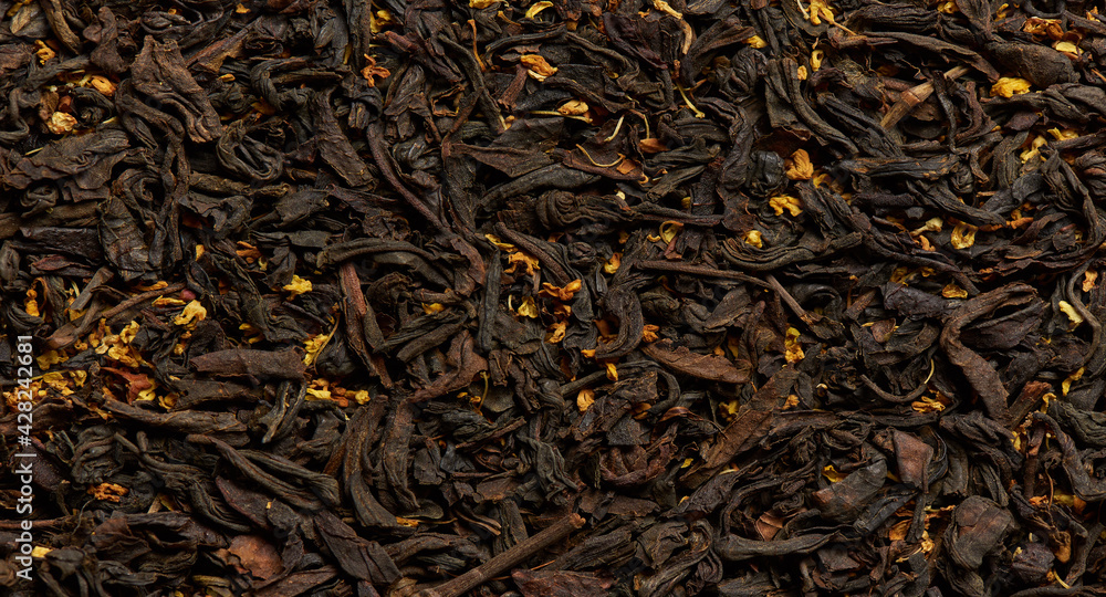 Tea texture with flower petals as a background.