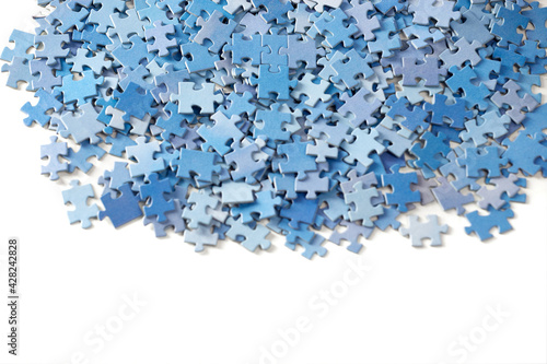 Many jigsaw puzzle pieces on white background.