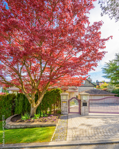 Luxury house with gates in Vancouver, Canada against blue sky