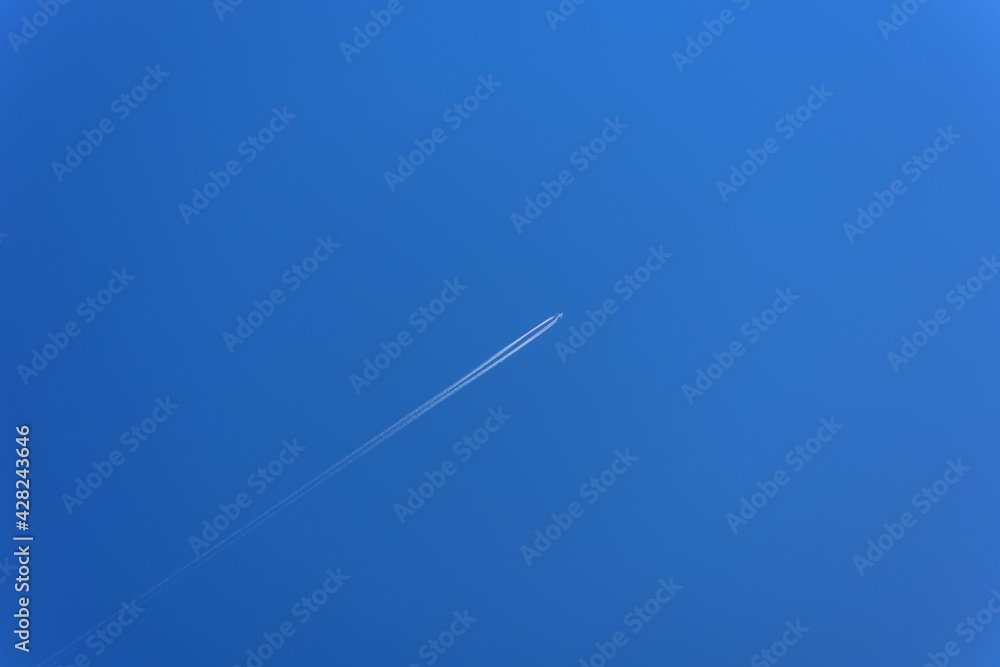 The plane is flying high in the blue clear sky The plane is flying high in the blue clear sky