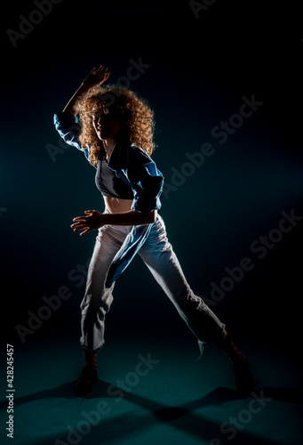 Dancer practicing modern dance isolated on dark background