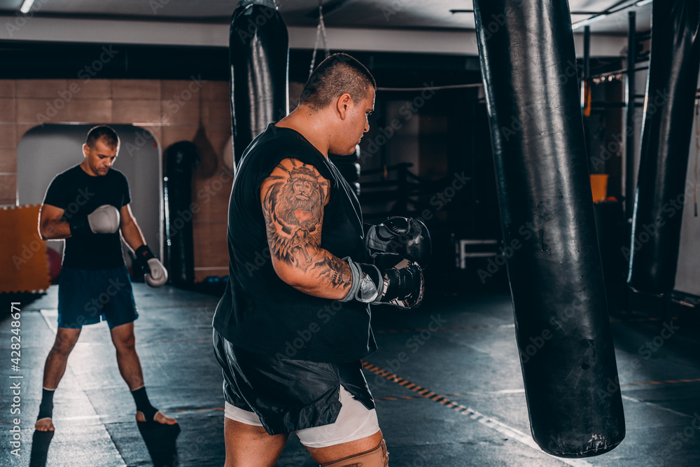 Fearles MMA Fighters practicing his punch on a punching bag