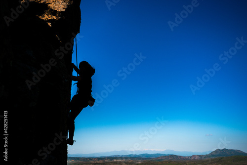 Rock climber preparing to the next move