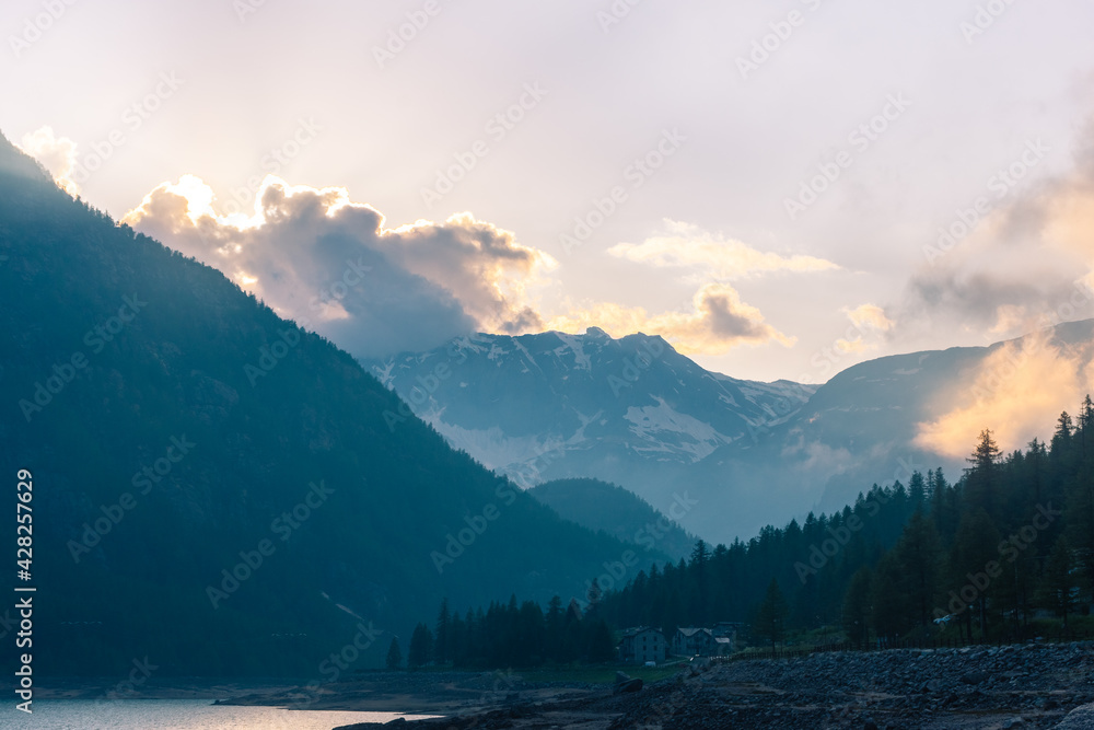 Obraz premium Sunset over the Ceresole Lake in the Italian Alps