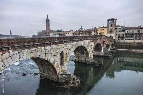 View of Stone Bridge (Ponte Pietra or Pons Marmoreus) - Roman arch bridge crossing the Adige River in Verona, Italy. The bridge completed in 100 BC, is the oldest bridge in Verona.