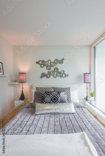 Modern bright bedroom interior with designer pillows in a luxury house
