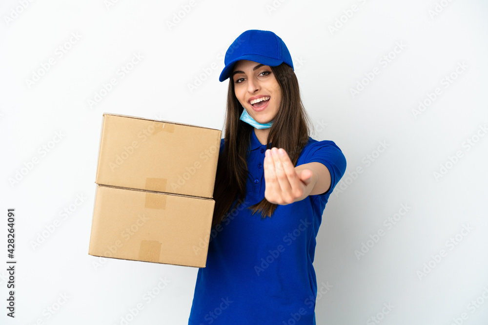 Delivery caucasian woman isolated on white background inviting to come with hand. Happy that you came Delivery caucasian woman isolated on white background inviting to come with hand. Happy that you came