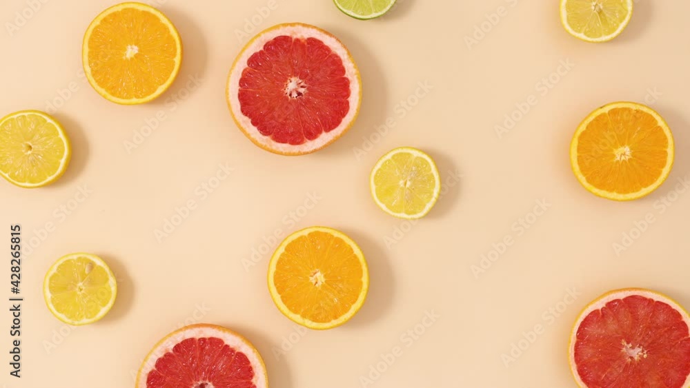 Citrus fruits make creative pattern on sandy background. Stop motion flat lay Citrus fruits make creative pattern on sandy background. Stop motion flat lay