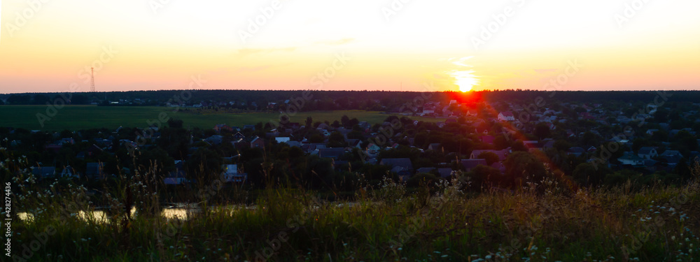 panorama overlooking the village and the dying sun at sunset.