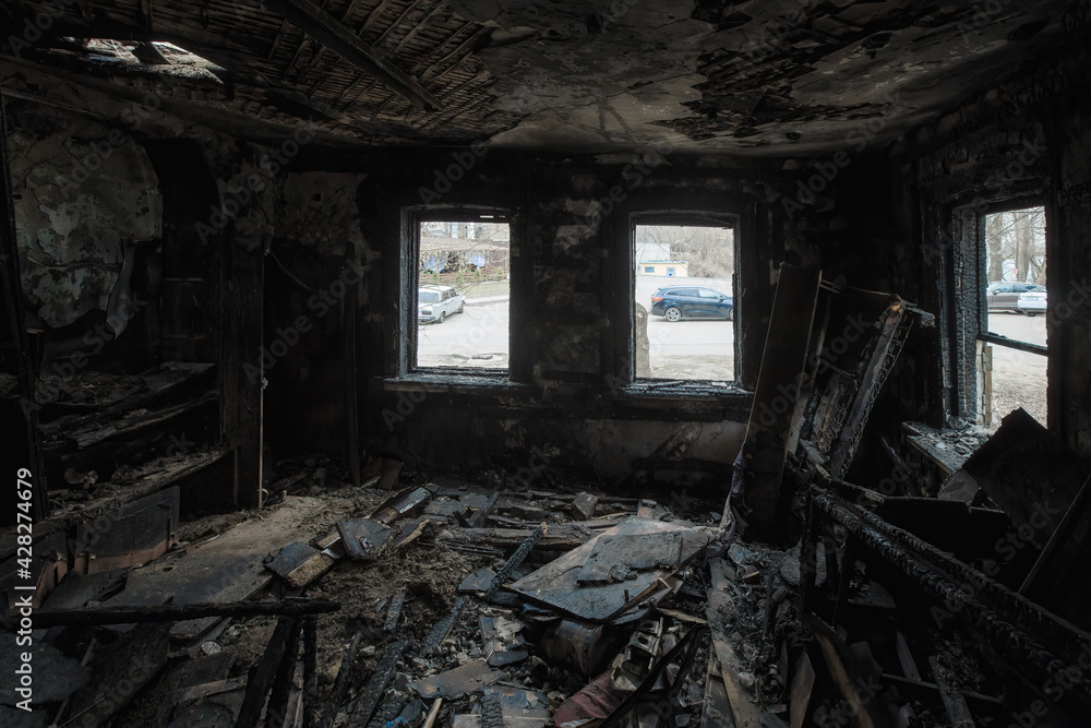 Burnt wooden house interior. Consequences of fire
