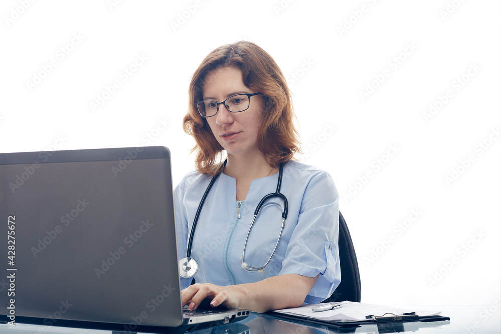 The doctor works at the laptop in the hospital. The doctor works at the laptop in the hospital.