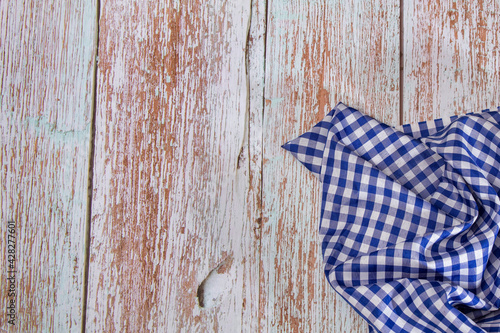 Blue checkered napkin on rustic wooden background