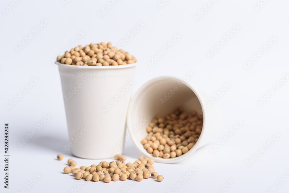soybean seeds in bowl and pouring on white background, Selective focus soybean seeds in bowl and pouring on white background, Selective focus