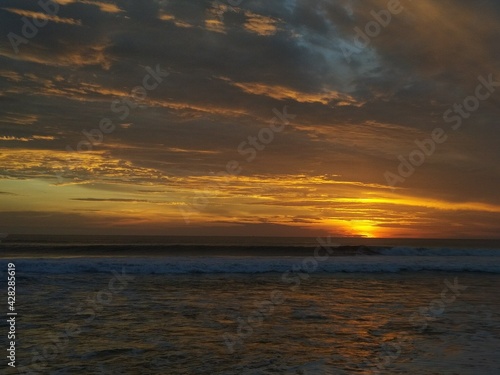 Beautiful cloudy sunset at Kuta beach  Bali  Indonesia. Kuta is the famous beach in Bali island. 