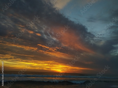 Beautiful cloudy sunset at Kuta beach  Bali  Indonesia. Kuta is the famous beach in Bali island. 