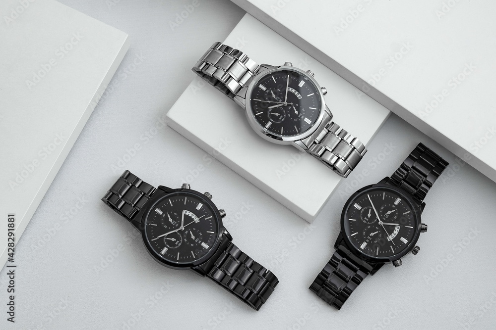 Luxury black and silver watch on white table. Monochromatic concept. Complementary color concept.