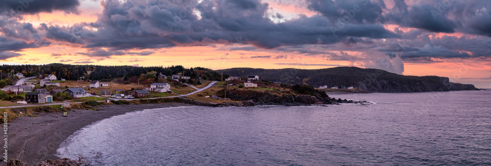 Panoramic view of a small town on the Atlantic Ocean Coast. Colorful Sunset Sky Art Render. Taken in Little Wild Cove, North Twillingate Island, Newfoundland and Labrador, Canada.